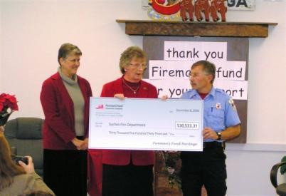 Lt. Ernie Pruitt receiving Fireman's Fund grant check.